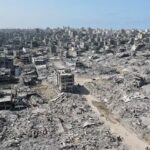 112661275-topshot-in-this-aerial-view-people-walk-amid-the-destruction-in-gaza-city-in-the-nor