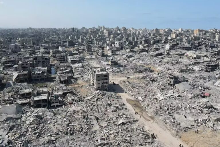 112661275-topshot-in-this-aerial-view-people-walk-amid-the-destruction-in-gaza-city-in-the-nor